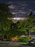 The full moon struggling to shine behind the clouds